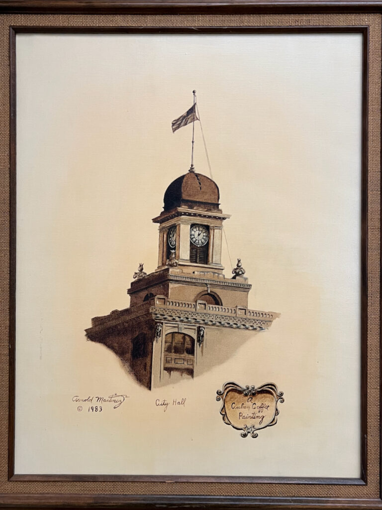 Painting of the top of Tampa City Hall in shades of brown. Signed Arnold Martinez 1983. A small banner in bottom corner says "A Cuban Coffee Painting."
